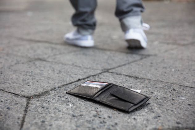 A lost identification card lying on the ground at a crime scene