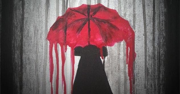 An open umbrella against a rainy sky