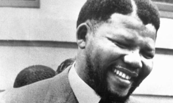 Nelson Mandela raising his fist in a symbol of resistance against Apartheid
