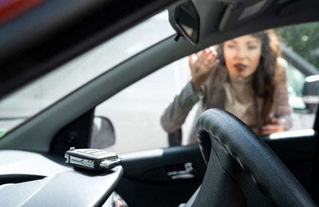 Woman looking suspiciously into a car window in a parking lot