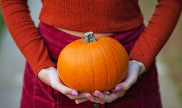 Woman holding a small pumpkin