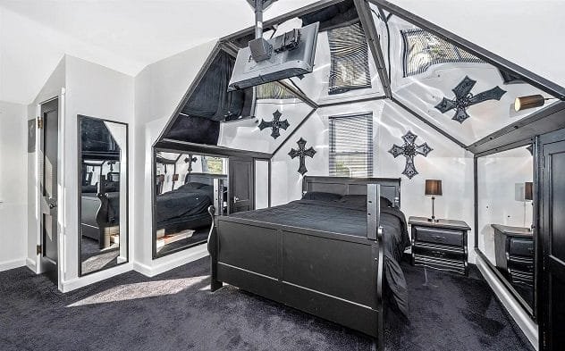 Interior of a house decorated in black and white with gothic elements like coffin lids
